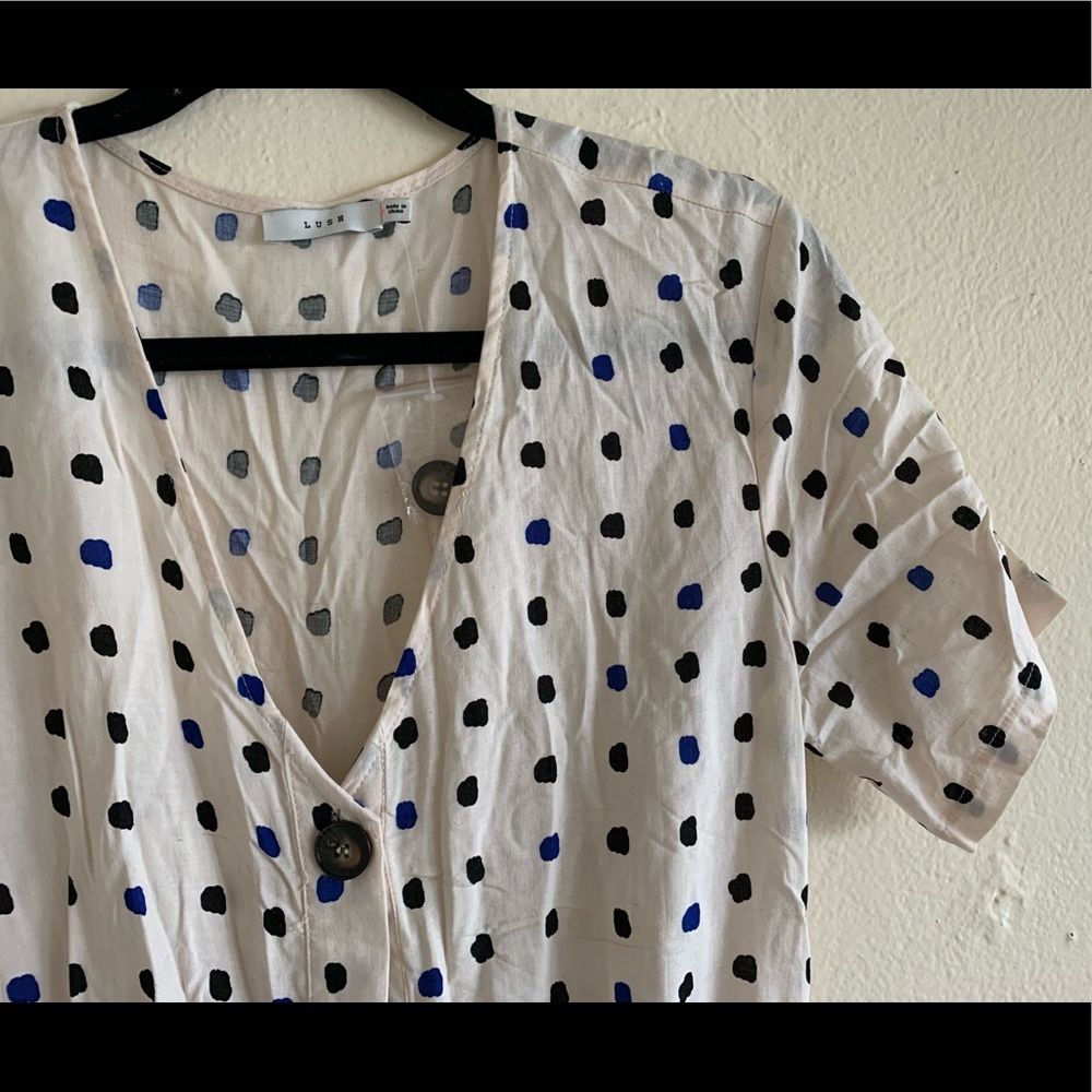 white jumpsuit with a black and blue dot pattern